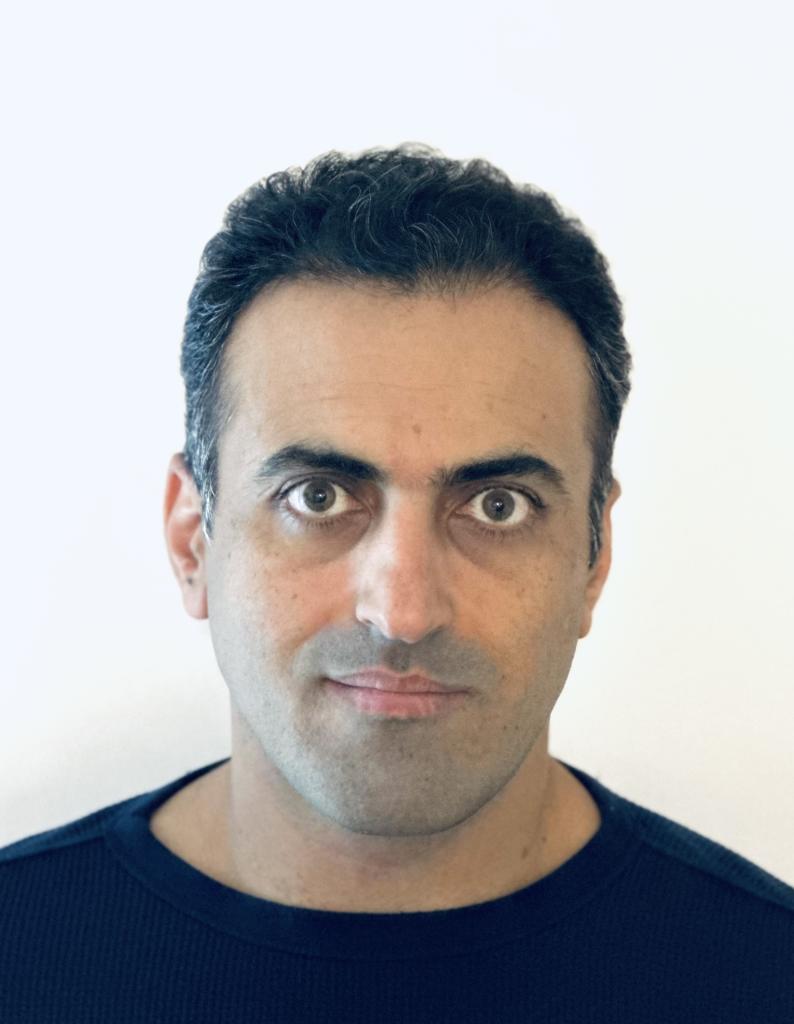 Dr. Esmaeel Ghasemi Gojani is in front of a white background. He is wearing a black shirt, and has short dark hair.