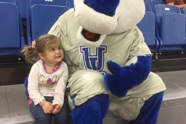 Dr. Michelle Helstein (Kinesiology & Physical Education) captured the moment when Luxie's biggest, little fan, Lucy, got to give the Pronghorn a big cuddle at Founders' Day Weekend Tailgate party!